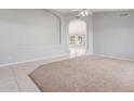 Spacious living room with neutral paint, carpet, tile flooring, and a ceiling fan at 21 E Irvine Rd, Phoenix, AZ 85086
