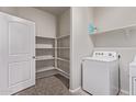 Functional laundry room featuring built-in shelving for optimal storage solutions at 28512 N Geode Dr, San Tan Valley, AZ 85143