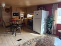 Well-lit kitchen and dining area with stainless steel appliances and wood-style flooring at 300 S Val Vista Dr # 77, Mesa, AZ 85204