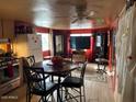 Open-concept living and dining area with table and television at 300 S Val Vista Dr # 77, Mesa, AZ 85204