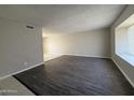 Spacious living room featuring modern floors and a window with natural light at 3827 E Sweetwater Ave, Phoenix, AZ 85032