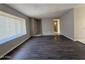 Bright living room showcasing fresh paint, stylish floors, and a large window at 3827 E Sweetwater Ave, Phoenix, AZ 85032
