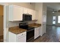 Bright kitchen featuring white cabinets, stainless steel appliances, and granite countertops at 4632 E Melinda Ln, Phoenix, AZ 85050