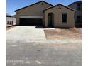 Exterior of a home featuring a two car garage, neutral stucco and front entry courtyard. New construction at 5721 E Iris Dr, Florence, AZ 85132