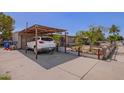 View of the car parked in the carport area, showcasing additional parking and storage space at 705 S Pima --, Mesa, AZ 85210