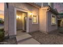 Inviting front entrance with stylish lighting, a small window, and easy access via concrete steps at 8468 W Lewis Ave, Phoenix, AZ 85037