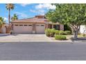 Charming home featuring a three-car garage, desert landscaping, and a tile roof at 8820 W Glenn Dr, Glendale, AZ 85305