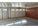 Clean, organized garage with ample storage cabinets and durable epoxy flooring at 8820 W Glenn Dr, Glendale, AZ 85305