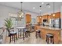 Bright kitchen with stainless appliances, granite counters, island, and pendant lighting at 8820 W Glenn Dr, Glendale, AZ 85305
