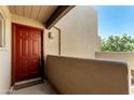 Welcoming entryway with a vibrant red front door, decorative details, and unit number at 11260 N 92Nd St # 2102, Scottsdale, AZ 85260