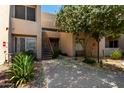 Condo exterior features a walkway, stairs to units above and lush vegetation and beautiful trees at 11260 N 92Nd St # 2102, Scottsdale, AZ 85260
