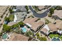 Aerial view of the home showcasing the pool, landscaped backyard, and tile roof in a quiet neighborhood at 11439 E Bella Vista St, Scottsdale, AZ 85259