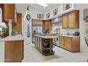 Spacious kitchen with light countertops, stainless steel appliances, a center island, and tasteful decorative accents at 11439 E Bella Vista St, Scottsdale, AZ 85259