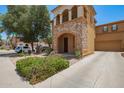 Attractive two-story home with a stone facade, balcony, covered porch, and desert landscaping at 11959 W Pierce St, Avondale, AZ 85323