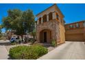 Stunning two-story house with a stone facade, private balcony, and well-maintained desert landscaping at 11959 W Pierce St, Avondale, AZ 85323