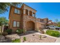Beautiful two-story home featuring a stone facade, balcony, covered porch, and low maintenance yard at 11959 W Pierce St, Avondale, AZ 85323