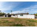 Charming single-story home featuring a manicured lawn and a brick-lined walkway at 126 E Northern Ave, Phoenix, AZ 85020