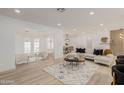 Expansive living area with seating and natural light showcases a modern aesthetic at 126 E Northern Ave, Phoenix, AZ 85020