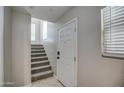 Bright entryway with a staircase leading to the upper level and tile flooring at 134 W Campbell Ct, Gilbert, AZ 85233