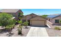 Charming single-story home featuring desert landscaping, a two-car garage, and a welcoming facade at 1384 S 222Nd Ln, Buckeye, AZ 85326