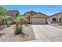 Charming single-story home featuring desert landscaping, a two-car garage, and a welcoming facade at 1384 S 222Nd Ln, Buckeye, AZ 85326