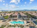 Overhead shot of a community pool and common areas with nearby residences and mountain views at 1441 N 80Th Ln, Phoenix, AZ 85043