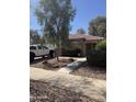 Attractive single story home featuring a tiled roof and desert landscaping at 15144 W Washington St, Goodyear, AZ 85338