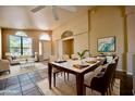 Bright and airy dining room featuring a table set for six, tile flooring, and a large window at 20443 N 39Th Dr, Glendale, AZ 85308