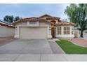 Single-story home showcasing a well-maintained lawn, desert landscaping, and a two-car garage at 2203 E Crest Ln, Phoenix, AZ 85024