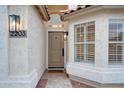Close-up of the front door and sidelight window, showcasing modern lighting fixtures at 2203 E Crest Ln, Phoenix, AZ 85024