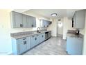 Well-equipped kitchen with plenty of storage, gray cabinets, modern appliances, and granite countertops at 3708 W Peoria Ave, Phoenix, AZ 85029