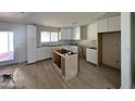 Bright kitchen space featuring new white cabinets and new floors waiting for final customization at 3725 E Karen Dr, Phoenix, AZ 85032