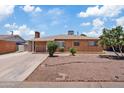 Traditional brick home with mature landscaping, a long driveway, and a welcoming facade at 4026 W Berridge W Ln, Phoenix, AZ 85019