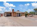 Single-story brick home with a spacious front yard and a convenient carport at 4026 W Berridge W Ln, Phoenix, AZ 85019