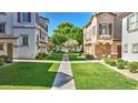 Serene neighborhood view showcasing lush green lawns and a peaceful walkway at 4169 E Jasper Dr, Gilbert, AZ 85296