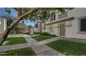 Charming townhome featuring a well-maintained lawn and inviting walkway to the front door at 4169 E Jasper Dr, Gilbert, AZ 85296