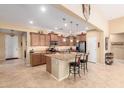 Spacious kitchen featuring granite countertops, a central island with seating, and modern appliances at 42709 W King Fisher Dr, Maricopa, AZ 85138