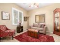 Cozy living room with a comfortable seating arrangement and a vintage-style trunk at 42709 W King Fisher Dr, Maricopa, AZ 85138
