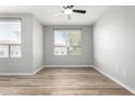 Bedroom features neutral walls, wood floors, ceiling fan and a window for natural light at 5303 N 7Th St # 326, Phoenix, AZ 85014