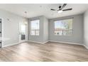Bright living room boasts wood floors, two large windows, and a stylish chandelier at 5303 N 7Th St # 326, Phoenix, AZ 85014