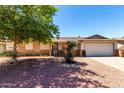 Charming single-story home featuring a low maintenance yard and a two-car garage at 617 E Calle Adobe Ln, Goodyear, AZ 85338