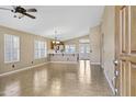 Inviting living room with tile flooring, and an open floor plan into the kitchen and dining area at 625 W Douglas Ave, Gilbert, AZ 85233