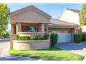 Charming single-story home featuring a front yard with manicured landscaping and a two-car garage at 7525 E Gainey Ranch Rd # 164, Scottsdale, AZ 85258
