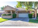 Charming single-story home featuring a front yard with manicured landscaping and a two-car garage at 7525 E Gainey Ranch Rd # 164, Scottsdale, AZ 85258