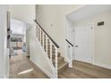 Elegant stairway with wood and white trim and luxury vinyl plank flooring on both levels at 7835 N 21St Dr, Phoenix, AZ 85021