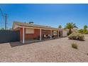 Low-angle view of a brick home with a covered carport and desert landscaping at 8155 E Columbus Ave, Scottsdale, AZ 85251