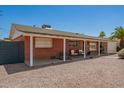 Low-angle view of a brick home with a covered carport and desert landscaping at 8155 E Columbus Ave, Scottsdale, AZ 85251