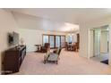 Cozy living room with plush carpeting, comfortable seating, and access to dining area at 8355 E Vía De Los Libros --, Scottsdale, AZ 85258