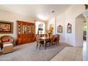 Traditional dining room with an elegant table set, classic hutch, and a cozy wicker chair at 9038 E Calle De Valle Dr, Scottsdale, AZ 85255