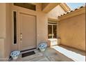 Charming front porch features a decorative door with stylish hardware and lovely accent decor at 9038 E Calle De Valle Dr, Scottsdale, AZ 85255
